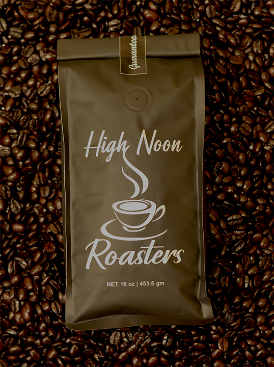 An image of a coffee beans bag by High Noon Roasters placed on coffee beans